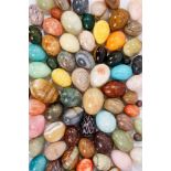 Large collection of specimen stone eggs, in excess of 100, the largest approximately 8cm long