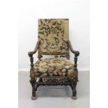 17th century style carved walnut open arm chair with needlework upholstered seat and back