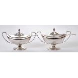 Fine quality pair of George III lidded sauce tureens and associated ladles.