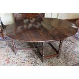 Late 17th century oak oval gateleg dining table of good patination, the elliptical hinged top on tur