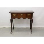 18th century oak lowboy with shaped top, three drawers, shaped apron on cabriole legs with Spanish t