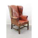 Georgian style red leather wing armchair with brass studded and buttoned decoration on square legs j