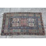 Old Persian rug with geometric medallions on red, blue and cream ground 210cm x 127cm