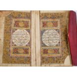 Antique Quran with illuminated pages in tooled red leather binding
