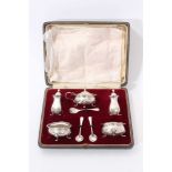 Early 20th century five piece condiment set, comprising pair of salts of compressed baluster form wi