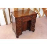George III mahogany kneehole dressing table with seven drawers and concelaed apron drawer about the