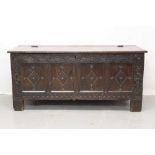 17th century carved oak coffer, with later hinged top and four lozenge panel front between scroll ca