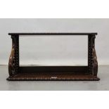 Early Victorian rosewood bookshelf with scroll supports