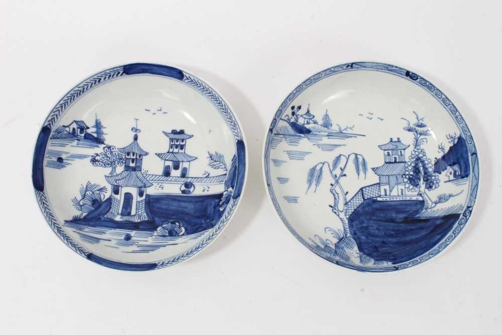 Two similar Lowestoft blue and white saucers, c.1790, painted with Oriental pagoda patterns, ex. Kit