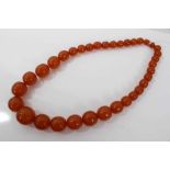 Large reconstituted amber bead necklace with a string of graduated reconstituted amber spherical bea