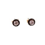 Pair of diamond and black enamel earrings, each with an old cut diamond in claw setting within a cir