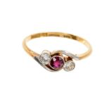 Edwardian ruby and diamond three stone ring with a central round mixed cut ruby flanked by two old c