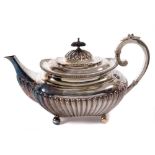 Edwardian silver teapot of half fluted form with engraved heraldic crests