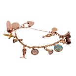 Charm bracelet with twelve gold and gilt metal charms to include antique locket and seals