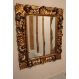 Florentine giltwood wall mirror, with rectangular plate and scrolling pierced foliate frame