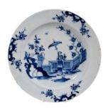 A good Lowestoft blue and white plate c.1770, painted with a Chinese lady holding a parasol, standin