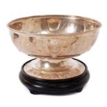Contemporary silver rose bowl and wooden stand.