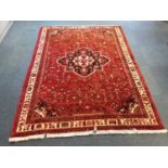 Eastern rug with geometric decoration on red, blue and cream ground 205cm x 152cm