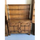 Ercol elm dresser with shelved back two drawers and two cupboard doors below H160cm W122cm D47cm