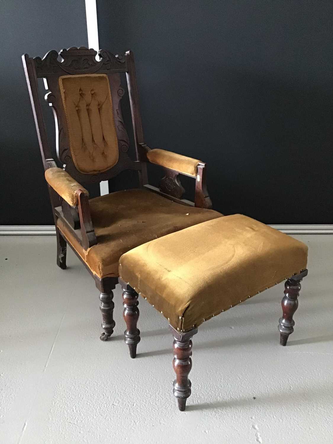 Edwardian mahogany carved low easy chair together with a matching stool H104cm W61.5cm D60cm