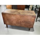 George III mahogany drop leaf table on square tapered legs together with a contemporary pine desk