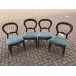 Set of four Victorian mahogany balloon back dining chairs upholstered in blue material on turned