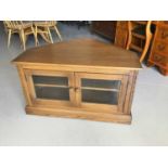 Ercol corner television cabinet/stand with two glazed doors below enclosing one adjustable shelf H55
