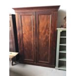 Large Victorian mahogany wardrobe with two panelled doors enclosing hanging rail, shelves and single