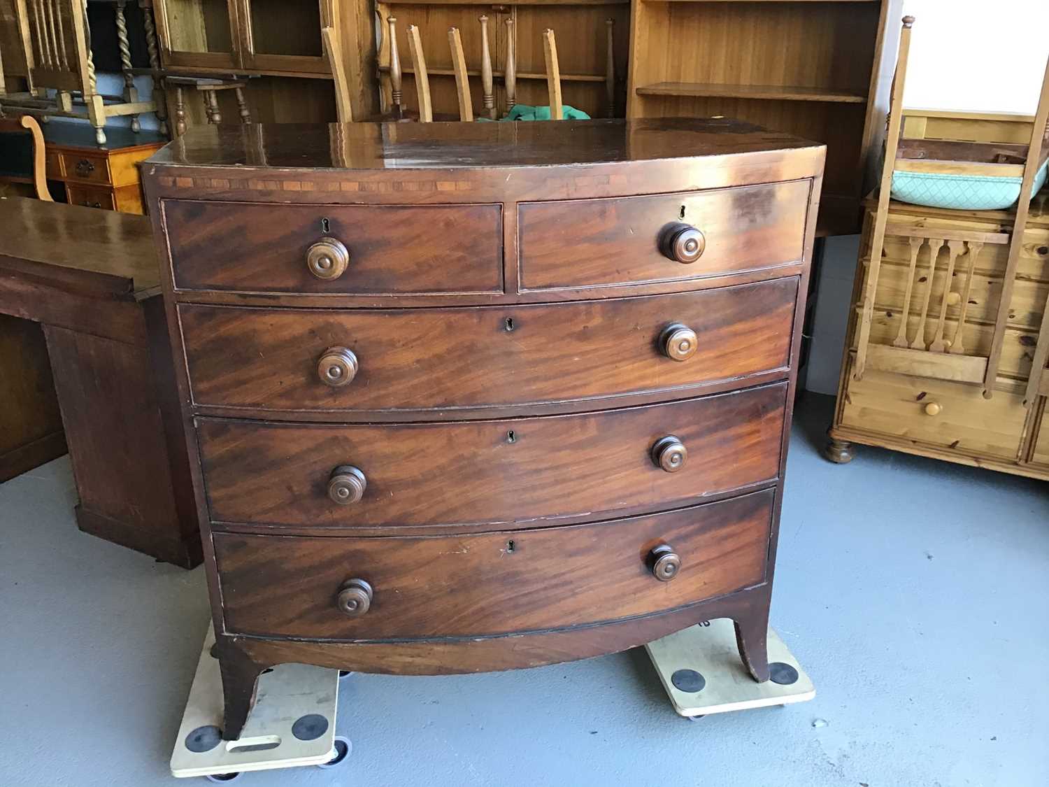 George III mahogany bow front chest of two short and three long drawers with turned handles on brac