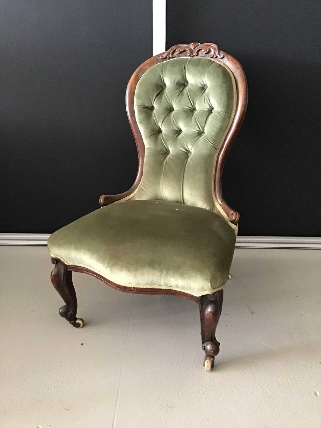 Victorian mahogany buttoned back easy chair upholstered in green material with carved front legs