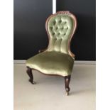 Victorian mahogany buttoned back easy chair upholstered in green material with carved front legs