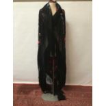 Large Chinese black silk embroidered shawl with deep knotted and tasselled fringing.