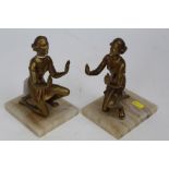 Pair of Art Deco style gilt patinated speller bookends, in the form of kneeling women, on alabaster