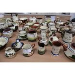 Large collection of Torquay motto ware including teapots, vases, jugs, dishes etc