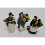 Three Royal Doulton figures - The Balloon Seller HN583, The Flower Seller HN989 and The Old Balloon