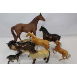 Five Beswick horses including Highland Pony and two Royal Doulton horses