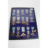 A glass case containing 15 assorted Masonic jewels