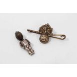 Fumsup good luck charm and silver gilt Royal Fusiliers bar brooch