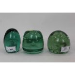 Three Victorian green glass dump weights to include one with a Sulphide figure