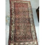 Hamadan rug with geometric floral pattern on red and cream ground 216cm x 106cm