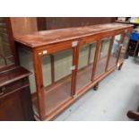 Large pine shop display cabinet on turned legs with bevelled glazed doors