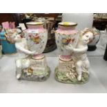Pair of Victorian Minton porcelain vases in the form of urns supported by putti