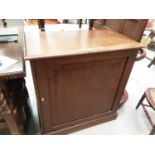 Edwardian oak cupboard with panelled door enclosing shelves, on plinth base