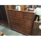 Edwardian walnut Gentleman's chest with deep central drawer, flanked by four short and three long gr