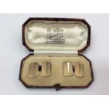 Pair of Art Deco 9ct gold cufflinks with engine turned decoration, possibly depicting the Empire Sta