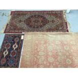 Three rugs to include a Keshan rug with central medallion on red ground 180cm x 91cm, Persian rug 94