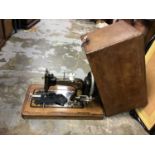 Three vintage sewing machines in cases including Jones