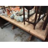 Hardwood table joined by stretcher together with four leather chairs