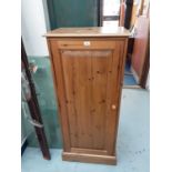 Pine narrow cupboard with adjustable shelves and panelled door