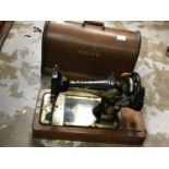 Four vintage sewing machines in cases including Singer
